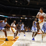 
              Tennessee guard Santiago Vescovi (25) passes the ball off as he's defended by McNeese State forward Roberts Berze (10) and guard Rhyjon Blackwell (3) during the first half of an NCAA college basketball game Wednesday, Nov. 30, 2022, in Knoxville, Tenn. (AP Photo/Wade Payne)
            