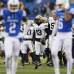 Vanderbilt linebacker CJ Taylor (13) runs down the field with the ball after making the game winning interception against Kentucky in an NCAA college football game in Lexington, Ky., Saturday, Nov. 12, 2022. (AP Photo/Michael Clubb)