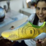 
              Paraguayan artist Lili Cantero holds a soccer shoe she hand-painted, in San Lorenzo, Paraguay, Thursday, Nov. 10, 2022. Decoratively detailing the lavish stadiums of the upcoming tournament in Qatar — the first to take place in the Middle East — as well as the most sought after players and teams, Cantero is preparing the last details of her soccer-inspired art show, “8 Stadiums, 8 Champions, 1 Dream: Qatar 2022.” (AP Photo/Jorge Saenz)
            