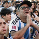
              Argentine soccer fans react as they watch their team's match against Mexico at the World Cup, hosted by Qatar, in Buenos Aires, Argentina, Saturday, Nov. 26, 2022. (AP Photo/Gustavo Garello)
            