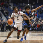 
              Connecticut's Tristen Newton (2) drives to the basket as Buffalo's Curtis Jones (3) defends in the first half of an NCAA college basketball game, Tuesday, Nov. 15, 2022, in Hartford, Conn. (AP Photo/Jessica Hill)
            
