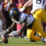 
              West Virginia running back Justin Johnson Jr. (26) recovers a fumble during the first half of an NCAA college football game against Iowa State, Saturday, Nov. 5, 2022, in Ames, Iowa. (AP Photo/Charlie Neibergall)
            
