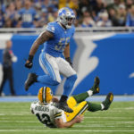 Green Bay Packers quarterback Aaron Rodgers (12) is sacked by Detroit Lions linebacker Derrick Barnes (55)during the first half of an NFL football game, Sunday, Nov. 6, 2022, in Detroit. (AP Photo/Paul Sancya)
