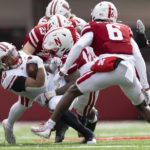 
              Nebraska's Isaac Gifford (23) and Ernest Hausmann (15) tackle Wisconsin's Isaac Guerendo (20) during the first half of an NCAA college football game Saturday, Nov. 19, 2022, in Lincoln, Neb. (AP Photo/Rebecca S. Gratz)
            