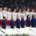 Denmark's players sing the national anthem before the World Cup group D soccer match between France and Denmark, at the Stadium 974 in Doha, Qatar, Saturday, Nov. 26, 2022. (AP Photo/Martin Meisner)