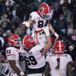
              Georgia wide receiver Ladd McConkey (84) gets a lift from offensive lineman Tate Ratledge (69) after scoring a touchdown during the second half of an NCAA college football game against Mississippi State in Starkville, Miss., Saturday, Nov. 12, 2022. (AP Photo/Rogelio V. Solis)
            