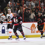 
              Ottawa Senators right wing Claude Giroux (28) passes Philadelphia Flyers right wing Owen Tippett (74) as he heads to the Senators bench to celebrate his goal during the first period of an NHL hockey game, Saturday, Nov. 5, 2022 in Ottawa, Ontario. (Justin Tang/The Canadian Press via AP)
            