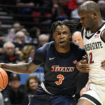 
              Cal State Fullerton guard Latrell Wrightsell Jr. (3) drives past San Diego State guard Adam Seiko (2) during the first half of an NCAA college basketball game Monday, Nov. 7, 2022, in San Diego. (AP Photo/Denis Poroy)
            