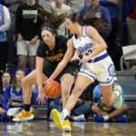 Drake forward Grace Berg (43) steals the ball from Iowa forward McKenna Warnock, left, during the first half of an NCAA college basketball game, Sunday, Nov. 13, 2022, in Des Moines, Iowa. (AP Photo/Charlie Neibergall)