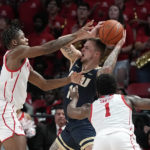 
              Houston's Jamal Shead (1) and Marcus Sasser, left, pressure Oral Roberts's Carlos Jurgens (11) during the second half of an NCAA college basketball game Monday, Nov. 14, 2022, in Houston. (AP Photo/David J. Phillip)
            