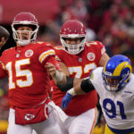 Kansas City Chiefs quarterback Patrick Mahomes (15) throws a pass as he is pressured by Los Angeles Rams defensive tackle Greg Gaines (91) during the first half of an NFL football game Sunday, Nov. 27, 2022, in Kansas City, Mo. (AP Photo/Charlie Riedel)