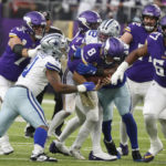 
              Minnesota Vikings quarterback Kirk Cousins (8) is sacked by Dallas Cowboys defensive end Dorance Armstrong (92) during the first half of an NFL football game, Sunday, Nov. 20, 2022, in Minneapolis. (AP Photo/Bruce Kluckhohn)
            