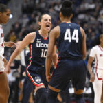 
              Connecticut's Nika Muhl (10) celebrates with Aubrey Griffin (44) during the first half of an NCAA basketball game against North Carolina State, Sunday, Nov. 20, 2022, in Hartford, Conn. (AP Photo/Jessica Hill)
            