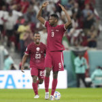 Qatar's Mohammed Muntari, front, celebrates after scoring his side's opening goal during the World Cup group A soccer match between Qatar and Senegal, at the Al Thumama Stadium in Doha, Qatar, Friday, Nov. 25, 2022. (AP Photo/Darko Bandic)