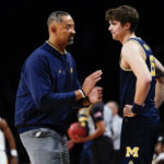 Michigan head coach Juwan Howard, left, talks to Joey Baker during the first half of an NCAA college basketball game against Arizona State in the championship round of the Legends Classic Thursday, Nov. 17, 2022, in New York. (AP Photo/Frank Franklin II)