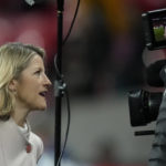 
              FILE - Jacqui Oatley of Britain's Sky Sports is working for the United States' Fox Sports as a touchline reporter during the women's friendly soccer match between England and the US at Wembley stadium in London, on Oct. 7, 2022. (AP Photo/Kirsty Wigglesworth, File)
            