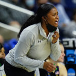 FILE - Notre Dame head coach Niele Ivey shouts to players during the first half of a college basketball game against North Carolina State in the Sweet Sixteen round of the NCAA women's tournament, Saturday, March 26, 2022, in Bridgeport, Conn.  The Atlantic Coast and Southeastern conferences have led the way among the power conferences in hiring coaches of color to lead women's basketball programs. (AP Photo/Frank Franklin II, File)
