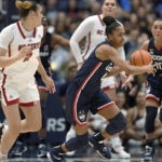 
              Connecticut's Aubrey Griffin, center, steals the ball from NC State's Mimi Collins, left, during the first half of an NCAA basketball game, Sunday, Nov. 20, 2022, in Hartford, Conn. (AP Photo/Jessica Hill)
            
