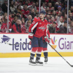 
              Washington Capitals right wing Garnet Hathaway (21) is escorted to the penalty box during the second period of the team's NHL hockey game against the Colorado Avalanche, Saturday, Nov. 19, 2022, in Washington. The Avalanche won 4-0. (AP Photo/Jess Rapfogel)
            