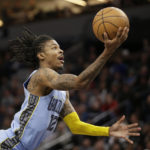 Memphis Grizzlies guard Ja Morant grabs the ball against the Minnesota Timberwolves in the second quarter of an NBA basketball game Wednesday, Nov. 30, 2022, in Minneapolis. (AP Photo/Andy Clayton-King)