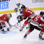 
              Chicago Blackhawks goaltender Dylan Wells makes a save on Winnipeg Jets' Kyle Connor (81) as Jason Dickinson (17) defends during the third period of an NHL hockey game in Winnipeg, Manitoba, Saturday, Nov. 5, 2022. (Fred Greenslade/The Canadian Press via AP)
            