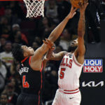 Chicago Bulls' Derrick Jones Jr. (5) goes up for a shot against Toronto Raptors' Scottie Barnes (4) during the first half of an NBA basketball game Monday, Nov. 7, 2022, in Chicago. (AP Photo/Paul Beaty)