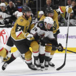 Arizona Coyotes center Barrett Hayton (29) gets squeezed by Vegas Golden Knights defenseman Alex Pietrangelo (7) and center Jonathan Marchessault during the first period of an NHL hockey game Thursday, Nov. 17, 2022, in Las Vegas. Marchessault was charged with interference on the play. (AP Photo/Sam Morris)