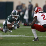 
              Michigan State running back Jarek Broussard, left, dives for yardage against Rutgers' Avery Young (2) during the first half of an NCAA college football game, Saturday, Nov. 12, 2022, in East Lansing, Mich. (AP Photo/Al Goldis)
            