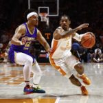 
              Tennessee guard Zakai Zeigler (5) drives against Tennessee Tech guard Erik Oliver (12) during the first half of an NCAA college basketball game Monday, Nov. 7, 2022, in Knoxville, Tenn. (AP Photo/Wade Payne)
            
