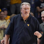 West Virginia head coach Bob Huggins talks to his team during the first half of an NCAA college basketball game against Pittsburgh, Friday, Nov. 11, 2022, in Pittsburgh. (AP Photo/Keith Srakocic)