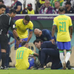 
              Brazil's Neymar, bottom, is treated by members of his team during the World Cup group G soccer match between Brazil and Serbia, at the Lusail Stadium in Lusail, Qatar, Thursday, Nov. 24, 2022. (AP Photo/Aijaz Rahi)
            