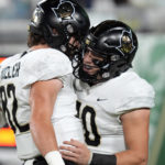 UCF quarterback John Rhys Plumlee (10) celebrates with tight end Alec Holler (82) after scoring on a 64-yard touchdown run against South Florida during the first half of an NCAA college football game Saturday, Nov. 26, 2022, in Tampa, Fla. (AP Photo/Chris O'Meara)