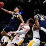 Michigan's Terrance Williams II (5) drives past Arizona State's Duke Brennan (24) during the first half of an NCAA college basketball game against Michigan in the championship round of the Legends Classic Thursday, Nov. 17, 2022, in New York. (AP Photo/Frank Franklin II)
