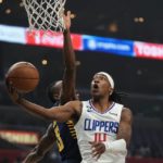 Los Angeles Clippers guard Terance Mann, right, shoots as Indiana Pacers forward Aaron Nesmith defends during the first half of an NBA basketball game Sunday, Nov. 27, 2022, in Los Angeles. (AP Photo/Mark J. Terrill)