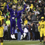 
              Washington wide receiver Taj Davis (3) celebrates with wide receiver Rome Odunze (1) after scoring as Oregon linebacker Jeffrey Bassa (33)  and defensive back Christian Gonzalez (0) look on during the second half of an NCAA college football game Saturday, Nov. 12, 2022, in Eugene, Ore. (AP Photo/Andy Nelson)
            
