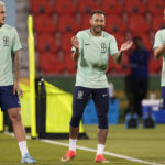 
              Brazil's Neymar, center, Pedro, left, and Thiago Silva exercise during a training session at the Grand Hamad stadium, in Doha, Qatar, Wednesday, Nov. 23, 2022. Brazil will play their first match in the World Cup against Serbia on Nov. 24. (AP Photo/Andre Penner)
            