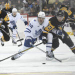 
              Pittsburgh Penguins left wing Brock McGinn (23) and Toronto Maple Leafs center Auston Matthews go for the puck during the second period of an NHL hockey game, Saturday, Nov. 26, 2022, in Pittsburgh. (AP Photo/Philip G. Pavely)
            