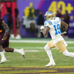 UCLA wide receiver Kazmeir Allen (19) runs for a touchdown as Arizona State defensive back Khoury Bethley (15) is unable to catch Allen during the second half of an NCAA college football game in Tempe, Ariz., Saturday, Nov. 5, 2022. UCLA won 50-36. (AP Photo/Ross D. Franklin)