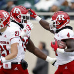 
              Rutgers' Aaron Young, right, celebrates his touchdown with Kwabena Asamoah, center, and Johnny Langan (21) against Michigan State during the first half of an NCAA college football game, Saturday, Nov. 12, 2022, in East Lansing, Mich. (AP Photo/Al Goldis)
            