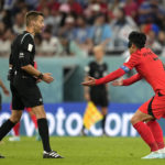 South Korea's Son Heung-min, right, discusses with referee Clement Turpin during the World Cup group H soccer match between Uruguay and South Korea, at the Education City Stadium in Al Rayyan , Qatar, Thursday, Nov. 24, 2022. (AP Photo/Lee Jin-man)
