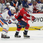 
              Edmonton Oilers center Connor McDavid, left, and Washington Capitals center Nic Dowd chase for possession of the puck in the first period of an NHL hockey game, Monday, Nov. 7, 2022, in Washington. (AP Photo/Patrick Semansky)
            