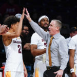 Arizona State head coach Bobby Hurley, center, celebrates with Alonzo Gaffney (32), Austin Nunez (2), Malcolm Flaggs and Desmond Cambridge Jr. (4) during the second half of an NCAA college basketball game against Michigan in the championship round of the Legends Classic Thursday, Nov. 17, 2022, in New York. Arizona State won 87-62. (AP Photo/Frank Franklin II)