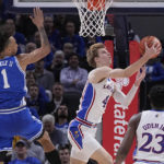 Kansas guard Gradey Dick (4) drives to the basket past Duke center Dereck Lively II (1) during the first half of an NCAA college basketball game, Tuesday, Nov. 15, 2022, in Indianapolis. (AP Photo/Darron Cummings)