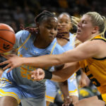 
              Southern guard Sirviva Legions (22) fights for a rebound with Iowa forward Monika Czinano, right, during the second half of an NCAA college basketball game, Monday, Nov. 7, 2022, in Iowa City, Iowa. (AP Photo/Charlie Neibergall)
            
