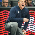 Xavier head coach Sean Miller shouts to his team during the second half of an NCAA college basketball game against Duke in the Phil Knight Legacy tournament Friday, Nov. 25, 2022, in Portland, Ore. (AP Photo/Rick Bowmer)