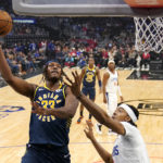 
              Indiana Pacers center Myles Turner, left, shoots as Los Angeles Clippers center Moses Brown defends during the first half of an NBA basketball game Sunday, Nov. 27, 2022, in Los Angeles. (AP Photo/Mark J. Terrill)
            