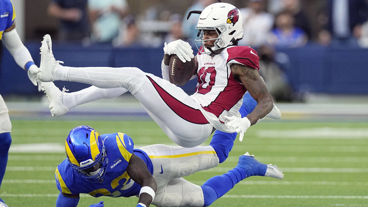 Arizona Cardinals wide receiver DeAndre Hopkins, top, is tackled by Los Angeles Rams safety Nick Sc...