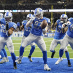 
              Detroit Lions defensive end Aidan Hutchinson (97) reacts after intercepting a pass intended for Green Bay Packers wide receiver Allen Lazard during the first half of an NFL football game, Sunday, Nov. 6, 2022, in Detroit. (AP Photo/Paul Sancya)
            