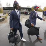 
              Arizona football players arrive at Rice-Eccles Stadium before their NCAA college football game against Utah Saturday, Nov. 5, 2022, in Salt Lake City. College athletic programs of all sizes are reacting to inflation the same way as everyone else. They're looking for ways to save. Travel and food are the primary areas with increased costs. (AP Photo/Rick Bowmer)
            