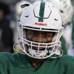 
              West Bloomfield running back Ralph Rogers, wearing eye black in the form of crosses on each cheek, stands on the sideline before a game against Eisenhower, Friday, Oct. 21, 2022, in West Bloomfield, Mich. (AP Photo/Carlos Osorio)
            
